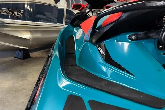 Slide: The Image of 2018 Sea-Doo Wake 155 jet ski in showroom, vibrant blue and red design. - 15