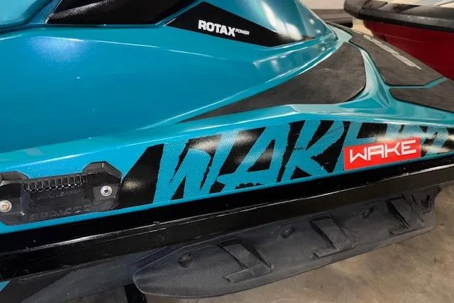 Slide: The Image of 2018 Sea-Doo Wake 155 jet ski with Rotax engine, blue and black design. - 7