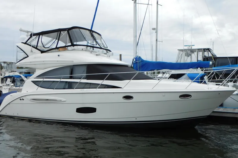 The Image of 2009 Meridian 391 Sedan yacht docked at marina, featuring sleek design and spacious upper deck. - 0
