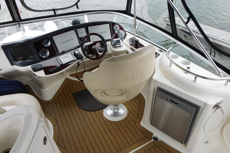 Slide: The Image of 2009 Meridian 391 Sedan helm with Garmin navigation, luxurious seating, and wood flooring. - 13
