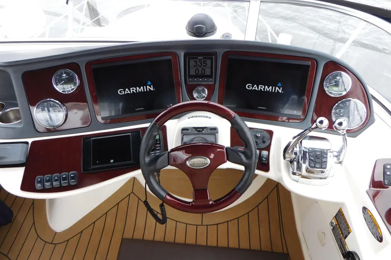 Slide: The Image of 2009 Meridian 391 Sedan helm with Garmin navigation displays and wood accents. - 16
