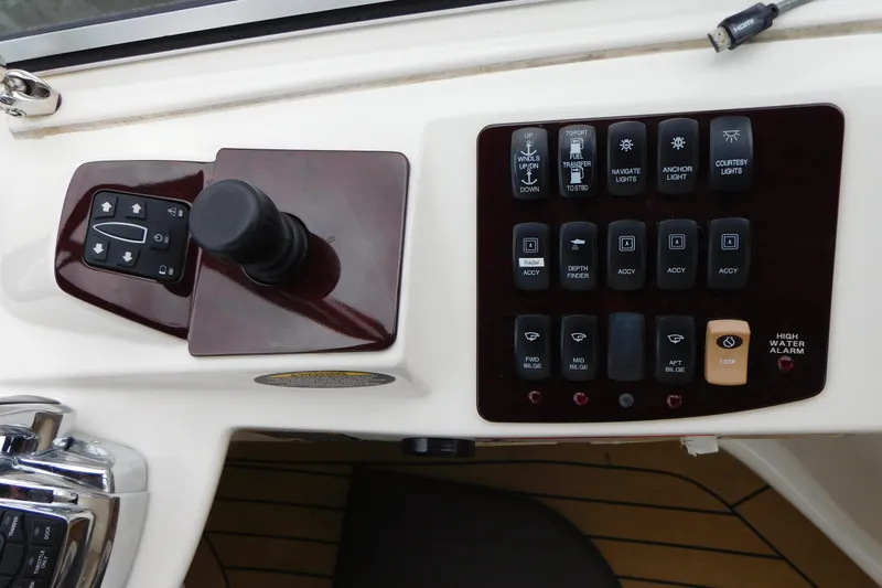 Slide: The Image of Control panel of a 2009 Meridian 391 Sedan boat with various switches and joystick. - 18