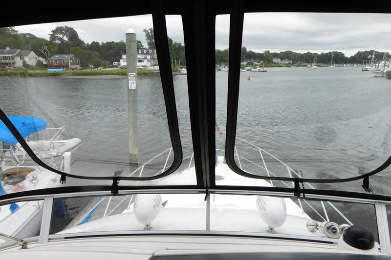 Slide: The Image of View from 2009 Meridian 391 Sedan yacht, overlooking a serene marina with houses and boats. - 19