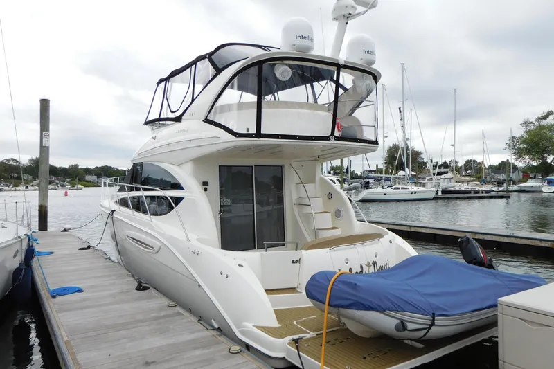 Slide: The Image of 2009 Meridian 391 Sedan yacht docked at marina with covered dinghy. - 3