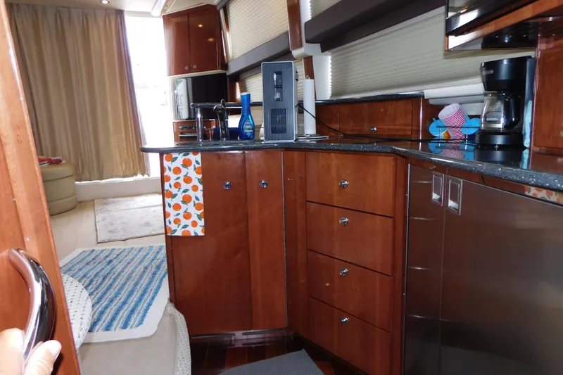Slide: The Image of 2009 Meridian 391 Sedan yacht interior with modern kitchen and wooden cabinetry. - 34