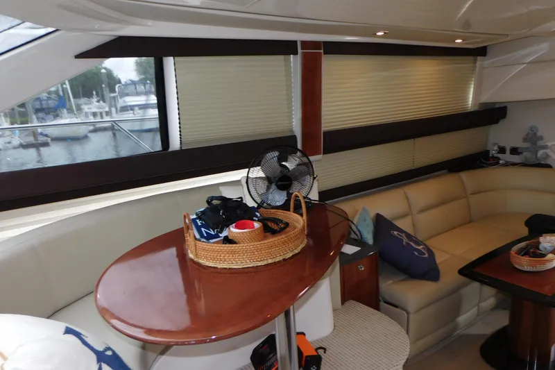 Slide: The Image of Interior of 2009 Meridian 391 Sedan yacht with beige seating and wooden table. - 37