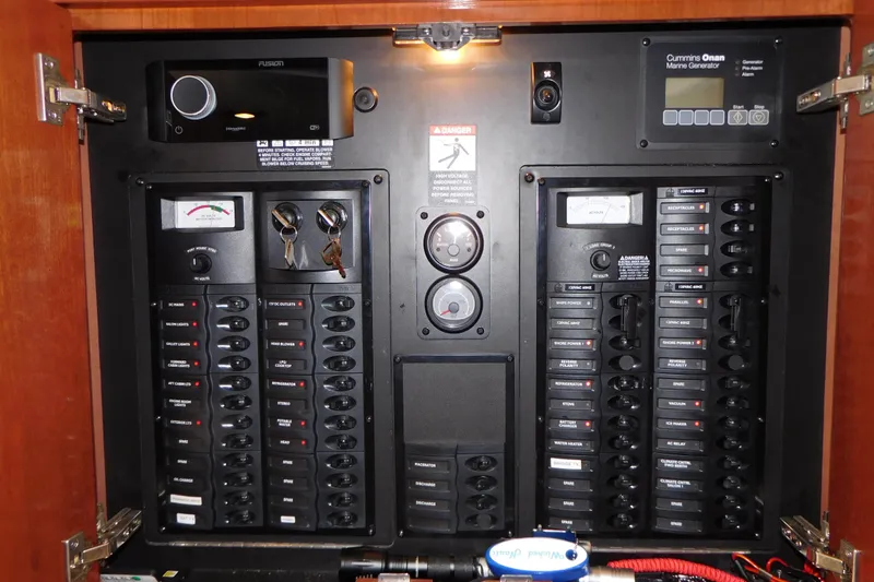Slide: The Image of Electrical control panel inside a 2009 Meridian 391 Sedan boat, featuring switches and gauges. - 38