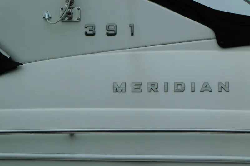 Slide: The Image of 2009 Meridian 391 Sedan boat nameplate, showcasing sleek design and branding. - 5