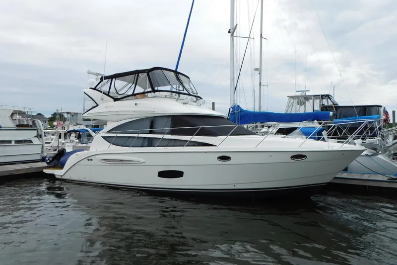 Slide: The Image of 2009 Meridian 391 Sedan yacht docked at marina, featuring sleek design and spacious upper deck. - 7
