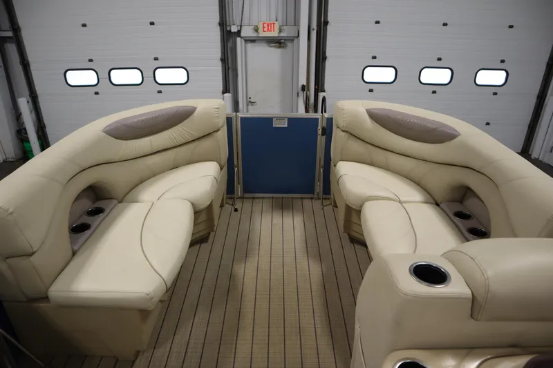 Slide: The Image of Interior of 2018 Sylvan 820 Mirage pontoon boat with beige seating and cup holders. - 11
