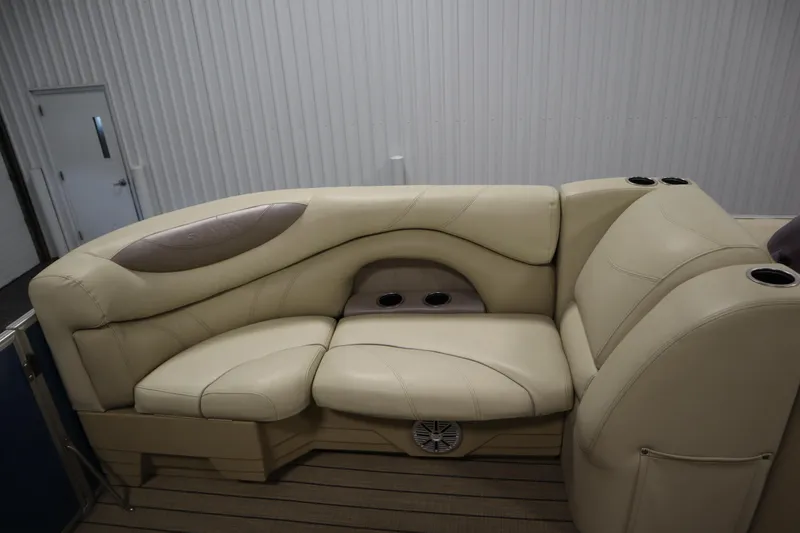 Slide: The Image of 2018 Sylvan 820 Mirage boat interior with beige seating and cup holders. - 14