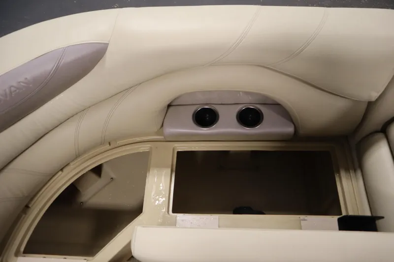 Slide: The Image of 2018 Sylvan 820 Mirage boat interior with beige seating and cup holders. - 15