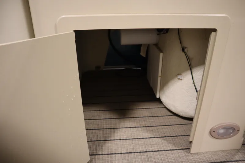 Slide: The Image of Open storage compartment in 2018 Sylvan 820 Mirage boat interior. - 17