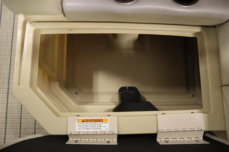 Slide: The Image of Storage compartment in a 2018 Sylvan 820 Mirage boat, featuring a warning label. - 31
