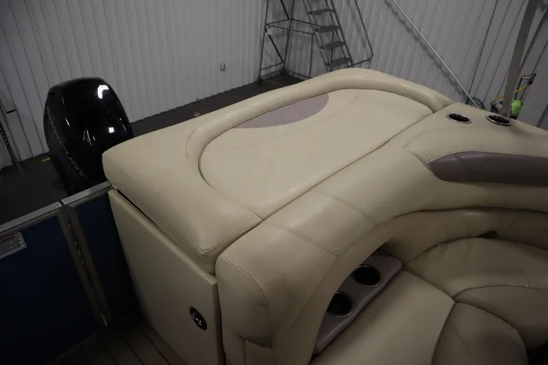 Slide: The Image of 2018 Sylvan 820 Mirage boat interior with beige seating and Mercury outboard motor. - 32