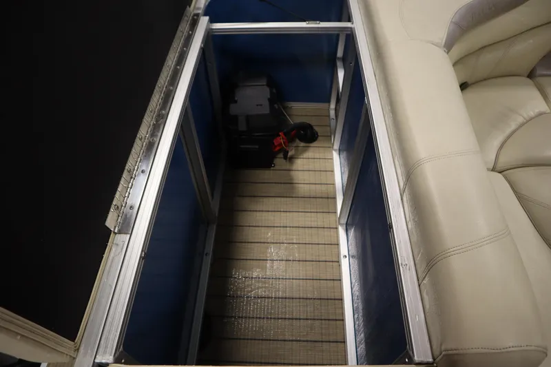 Slide: The Image of Storage compartment in 2018 Sylvan 820 Mirage boat with beige seating. - 33