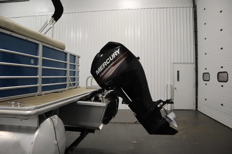 Slide: The Image of 2018 Sylvan 820 Mirage pontoon boat with Mercury outboard motor in a garage. - 35