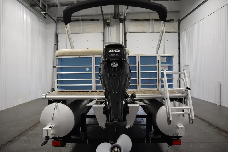 Slide: The Image of 2018 Sylvan 820 Mirage pontoon boat with outboard motor in a storage facility. - 6