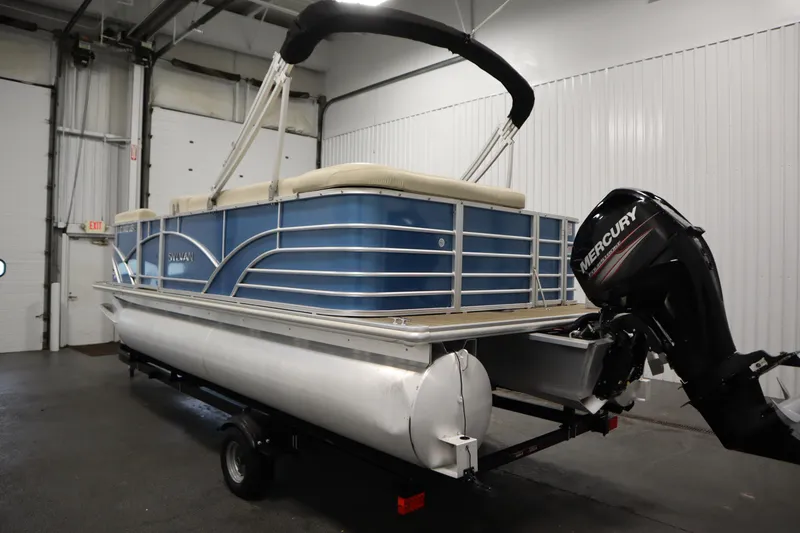 Slide: The Image of 2018 Sylvan 820 Mirage pontoon boat with Mercury outboard motor in indoor storage. - 7