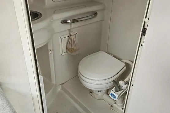 Slide: The Image of 1997 Chris-Craft 30 Crowne boat bathroom with toilet and sink. - 3