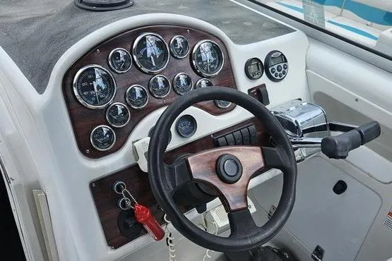 Slide: The Image of 1997 Chris-Craft 30 Crowne boat dashboard with gauges and steering wheel. - 4