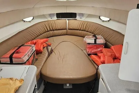 Slide: The Image of 1997 Chris-Craft 30 Crowne cabin interior with life jackets and seating area. - 7