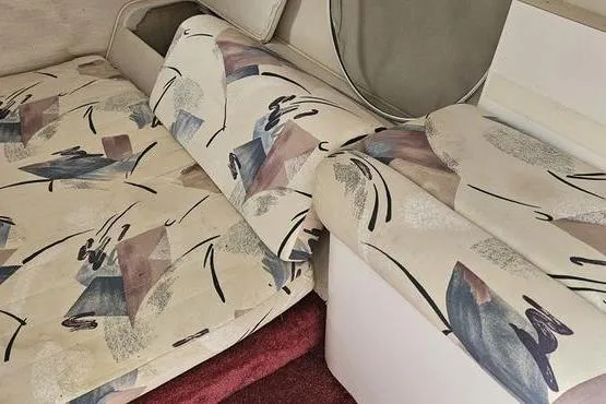 Slide: The Image of 1997 Chris-Craft 30 Crowne interior with abstract-patterned upholstery and red carpet. - 9