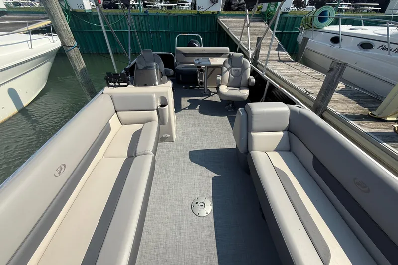 Slide: The Image of 2022 Princecraft Vectra 23 RL pontoon boat interior with spacious seating and helm. - 10