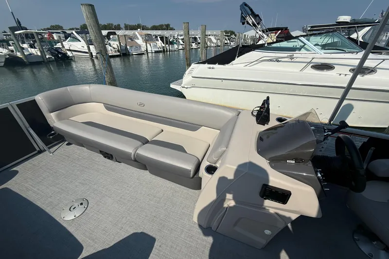 Slide: The Image of 2022 Princecraft Vectra 23 RL pontoon boat interior with seating and helm, docked at marina. - 12
