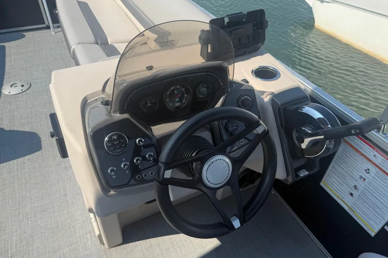 Slide: The Image of 2022 Princecraft Vectra 23 RL boat dashboard with steering wheel and controls. - 14