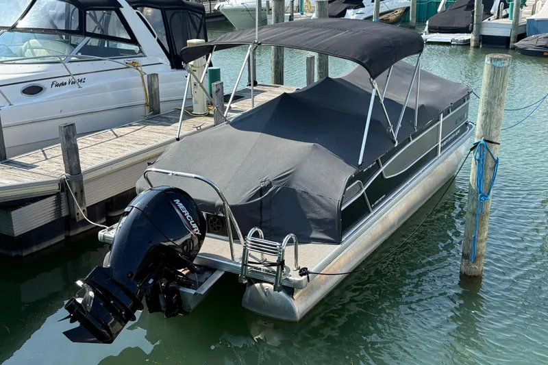 Slide: The Image of 2022 Princecraft Vectra 23 RL pontoon boat docked with Mercury outboard motor. - 19