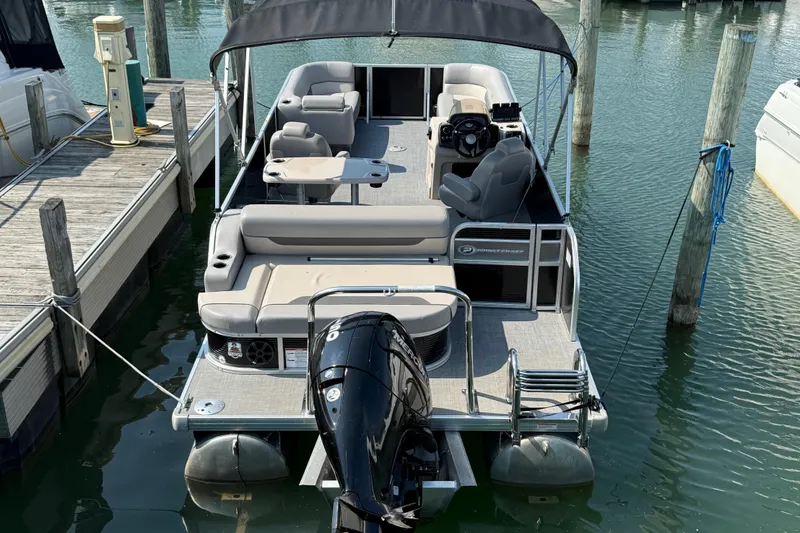 Slide: The Image of 2022 Princecraft Vectra 23 RL pontoon boat docked, featuring spacious seating and modern design. - 2