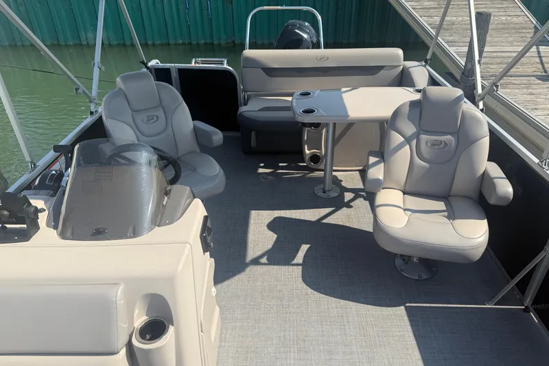 Slide: The Image of 2022 Princecraft Vectra 23 RL pontoon boat interior with plush seating and table. - 7