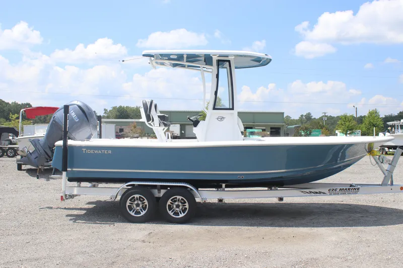 The Image of 2026 Tidewater 2210 Carolina Bay boat on trailer, blue hull, outdoor setting. - 0