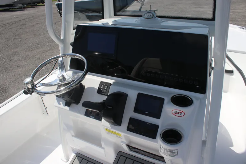 Slide: The Image of 2026 Tidewater 2210 Carolina Bay boat console with steering wheel and modern controls. - 13