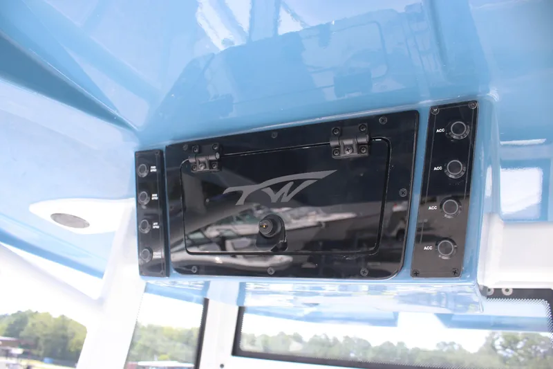 Slide: The Image of 2026 Tidewater 2210 Carolina Bay boat console with control panel and storage compartment. - 16