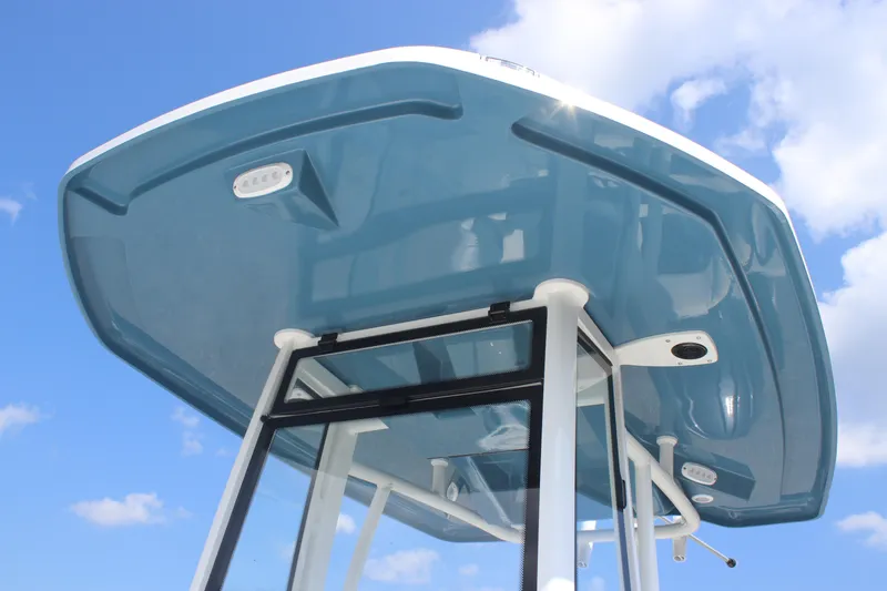 Slide: The Image of 2026 Tidewater 2210 Carolina Bay boat T-top against a clear blue sky. - 17