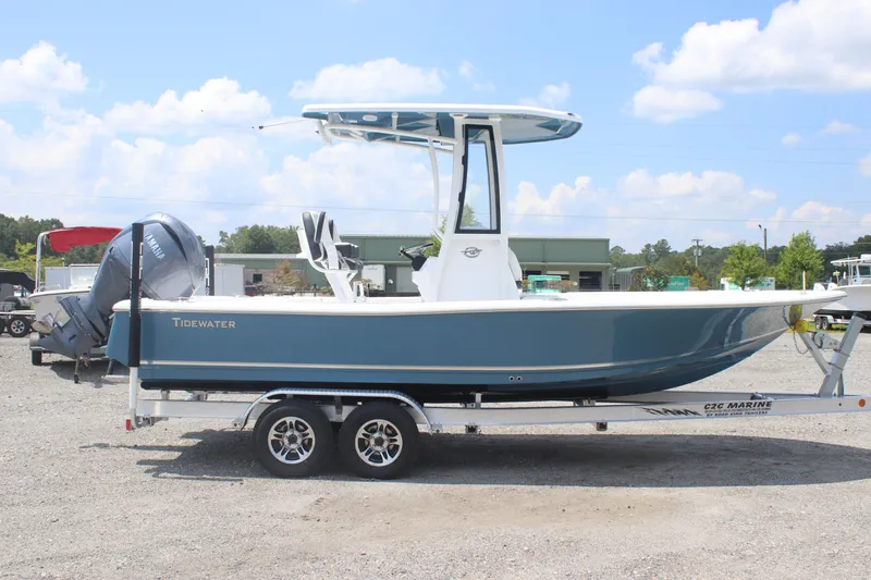 Slide: The Image of 2026 Tidewater 2210 Carolina Bay boat on trailer, parked outdoors under blue sky. - 3
