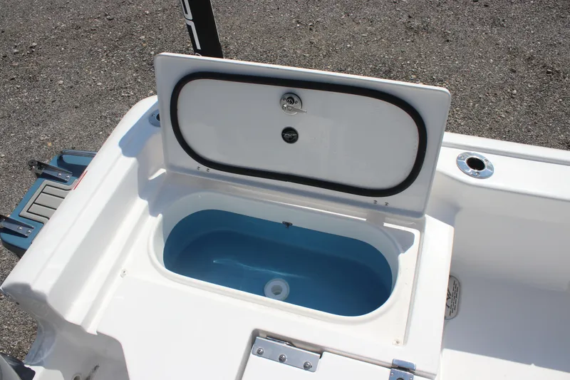Slide: The Image of 2026 Tidewater 2210 Carolina Bay boat livewell with open lid, showcasing interior. - 7