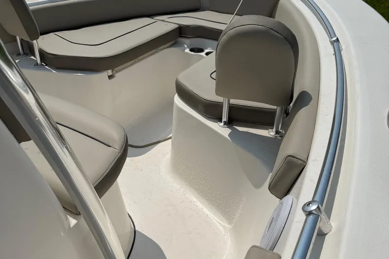 Slide: The Image of 2022 Key West 219 FS boat interior with cushioned seating and stainless steel railings. - 3