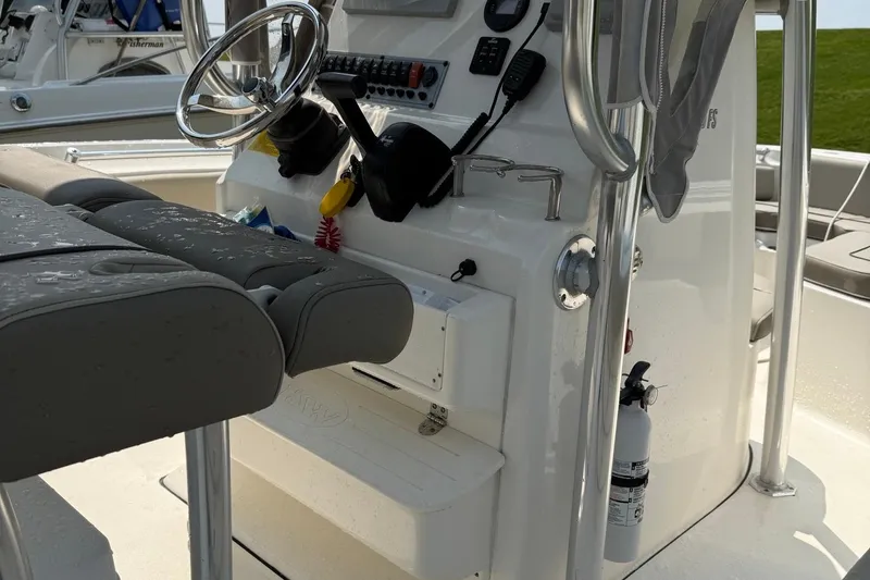 Slide: The Image of 2022 Key West 219 FS boat console with steering wheel and controls. - 4