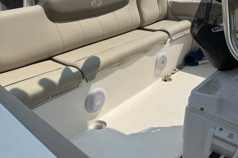 Slide: The Image of 2022 Key West 219 FS boat interior with beige seating and built-in speakers. - 5