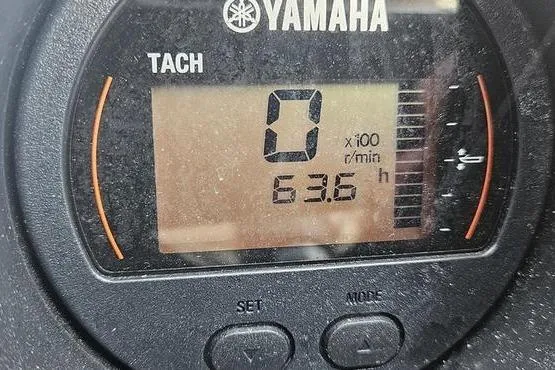 Slide: The Image of Yamaha tachometer displaying 0 RPM and 63.6 hours on a 2016 Bennington 2575 RCW. - 2