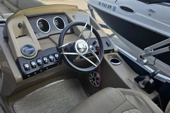Slide: The Image of 2016 Bennington 2575 RCW boat dashboard with steering wheel and control panel. - 3
