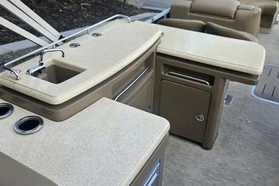 Slide: The Image of 2016 Bennington 2575 RCW boat interior with beige countertops and sink. - 4