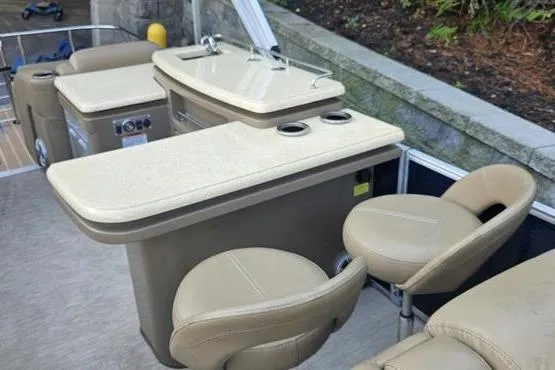 Slide: The Image of 2016 Bennington 2575 RCW boat interior with beige seating and sleek countertops. - 5