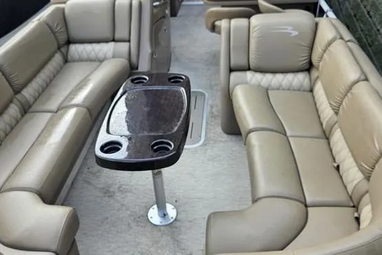 Slide: The Image of 2016 Bennington 2575 RCW boat interior with beige seating and a central table. - 7