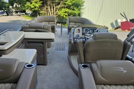 Slide: The Image of 2016 Bennington 2575 RCW pontoon boat interior with luxurious seating and modern dashboard. - 9