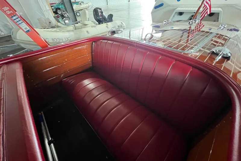 Slide: The Image of 1947 Chris Craft Barrel Back boat interior with red leather seats and wooden accents. - 6