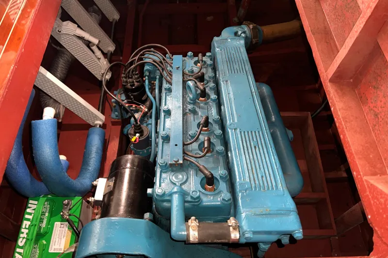 Slide: The Image of Engine of a 1947 Chris Craft Barrel Back boat, featuring a blue inline engine. - 7